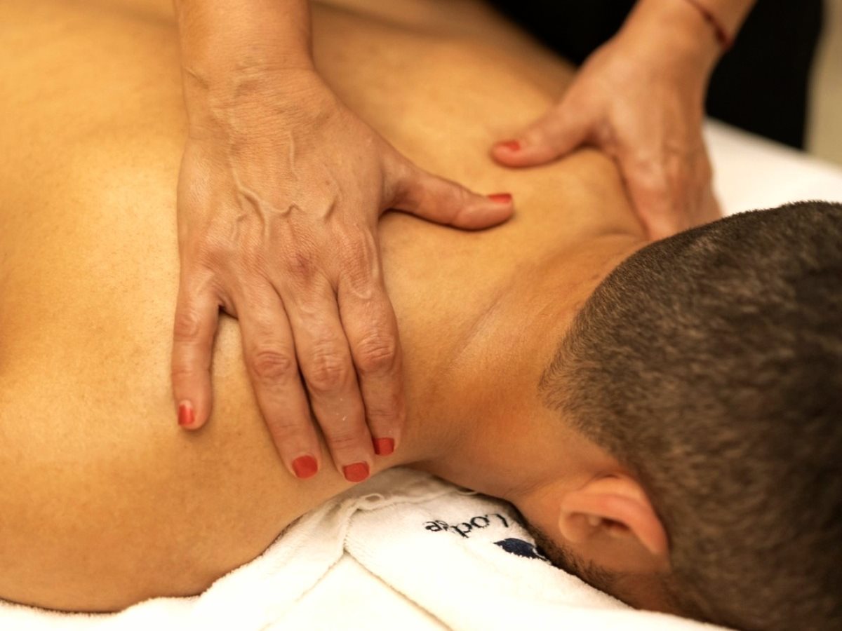 Hands working on the shoulders and upper back