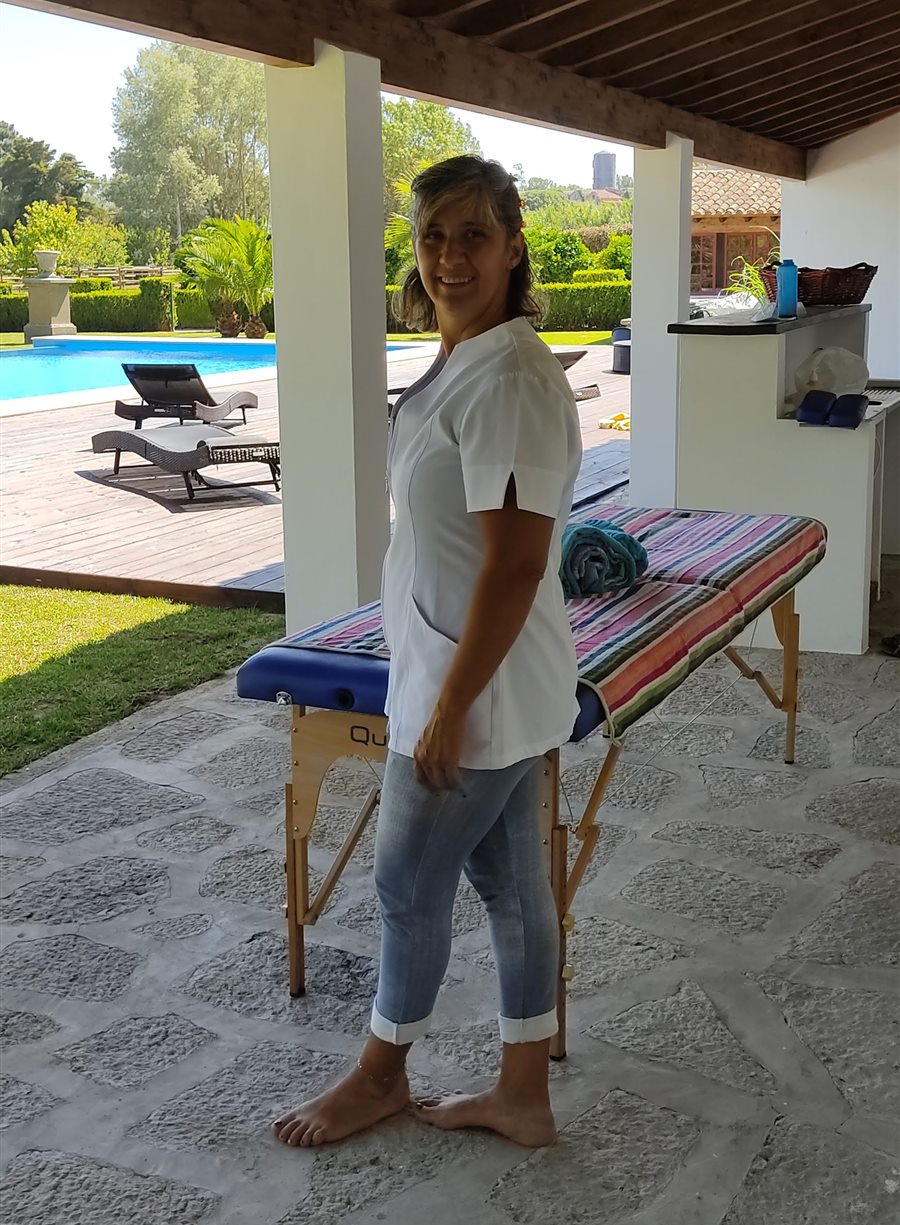 Ana beside the massage table on the same villa porch